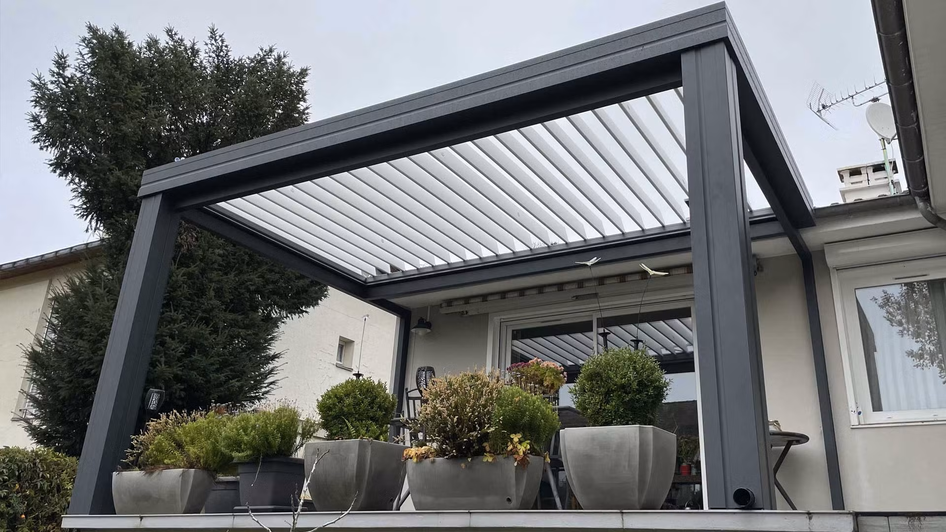 Metal pergola overlooking an outdoor terrace